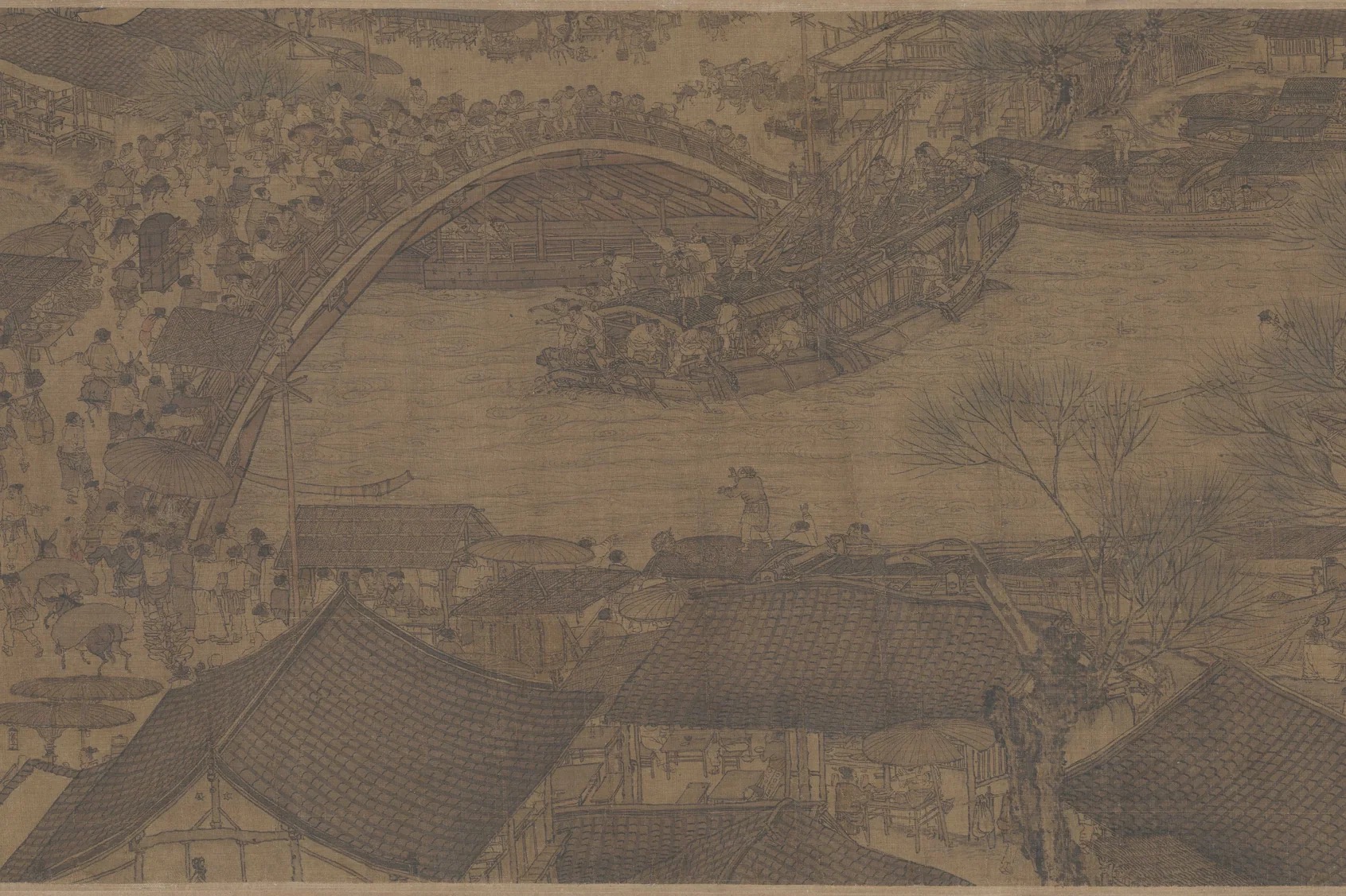 Detail from Zhang Zeduan’s handscroll showing the arched Rainbow Bridge crowded with people and a masted boat passing beneath it.
